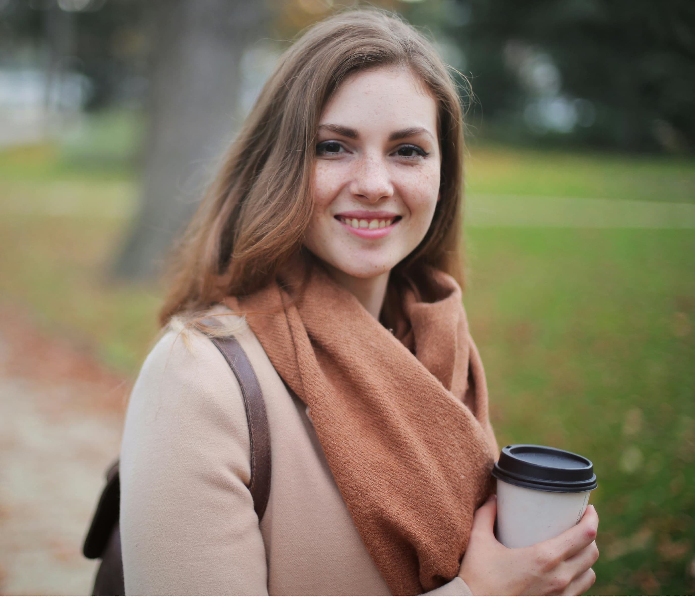 Woman holding coffee outdoors